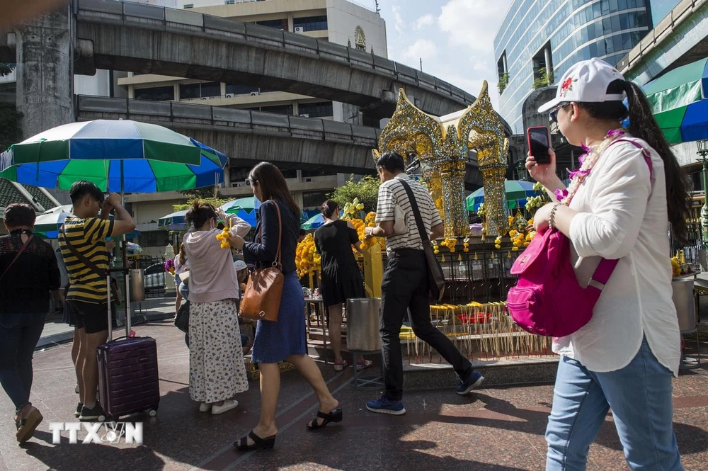 Khách du lịch tham quan đền Erawan ở thủ đô Bangkok của Thái Lan. (Ảnh: AFP/TTXVN)