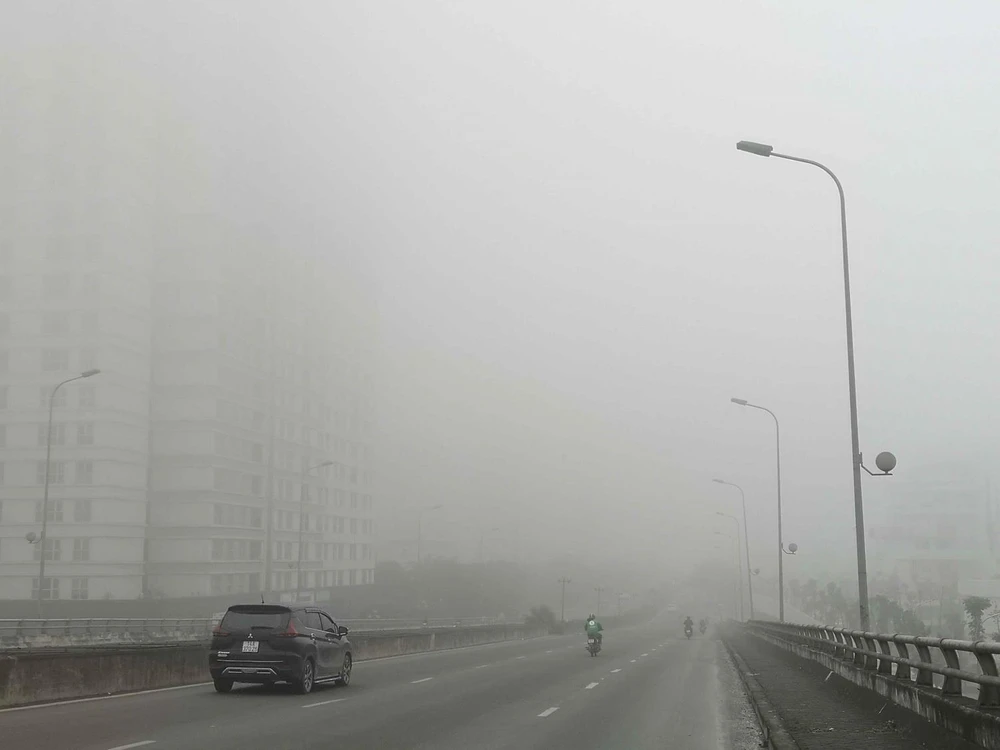 Khu vực quận Hà Đông, Hà Nội vẫn đang bị sương mù bao phủ, tầm nhìn của người tham gia giao thông bị hạn chế. (Ảnh: Thanh Tùng/TTXVN)