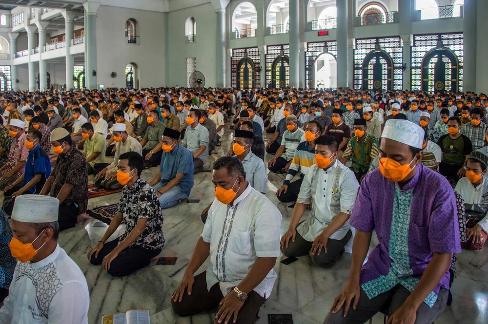 Người dân Indonesia đeo khẩu trang phòng dịch COVID-19 khi tham dự lễ cầu nguyện Ngày Thứ Sáu tại nhà thờ ở Surakarta, Đông Java, ngày 20/3 vừa qua. (Ảnh: AFP/TTXVN)
