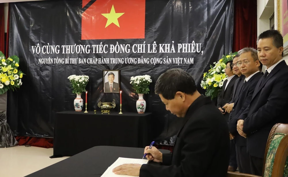 Đại sứ Lê Quý Quỳnh ghi sổ tang tại lễ viếng nguyên Tổng Bí thư Lê Khả Phiêu. (Ảnh: TTXVN/phát)
