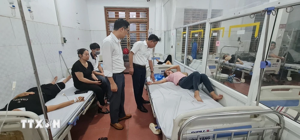Giám đốc Sở Y tế tỉnh Vĩnh Phúc Lê Hồng Trung thăm hỏi, kiểm tra sức khỏe công nhân bị ngộ độc thực phẩm đang được điều trị tại Trung tâm y tế thành phố Vĩnh Yên. (Ảnh: Nguyễn Thảo/TTXVN)