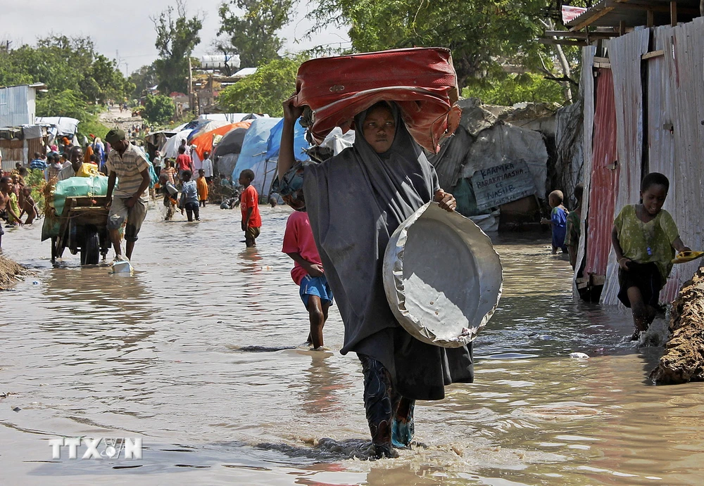 Người dân sơ tán khỏi vùng ngập lụt sau những trận mưa lớn tại Mogadishu, Somalia. (Ảnh: AFP/TTXVN)