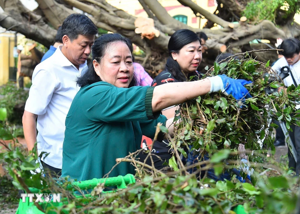 Bí thư Thành ủy Hà Nội Bùi Thị Minh Hoài tham gia vệ sinh môi trường cùng người dân tại phố Trần Hưng Đạo, quận Hoàn Kiếm. (Ảnh: TTXVN phát)