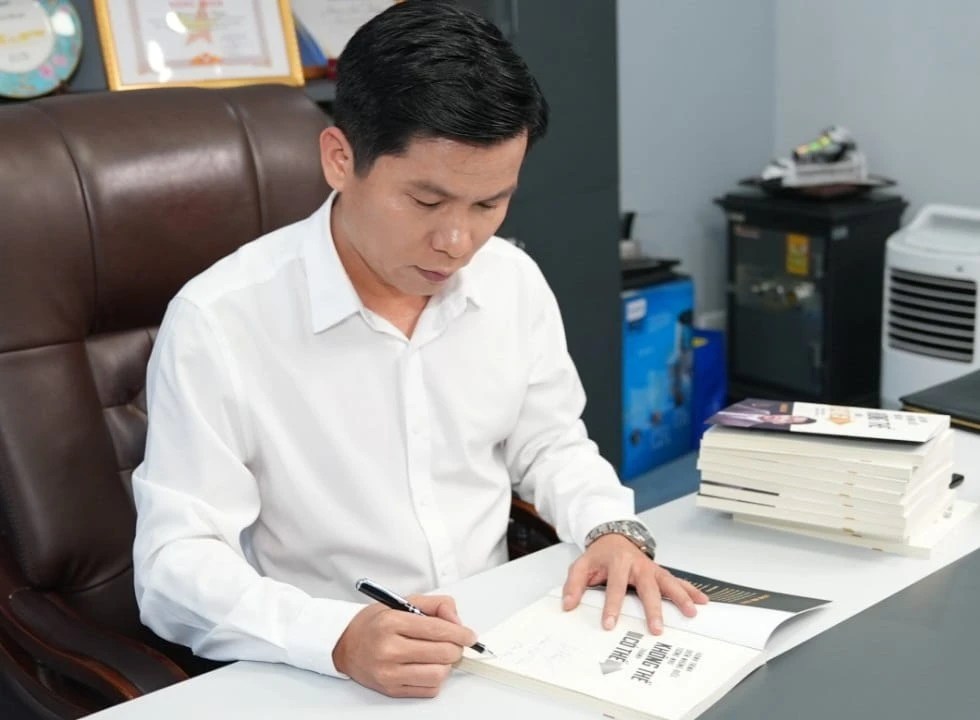 Tác giả Hoàng Hữu Thắng ký tặng sách cho độc giả. (Ảnh: NVCC)