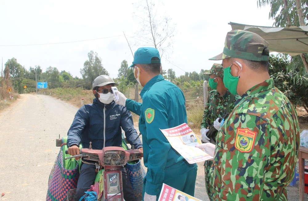 Lực lượng Bộ đội biên phòng tuyên truyền về các biện pháp phòng, chống dịch bệnh COVID-19 cho người dân trên vùng biên giới. (Ảnh: Văn Khương/TTXVN)