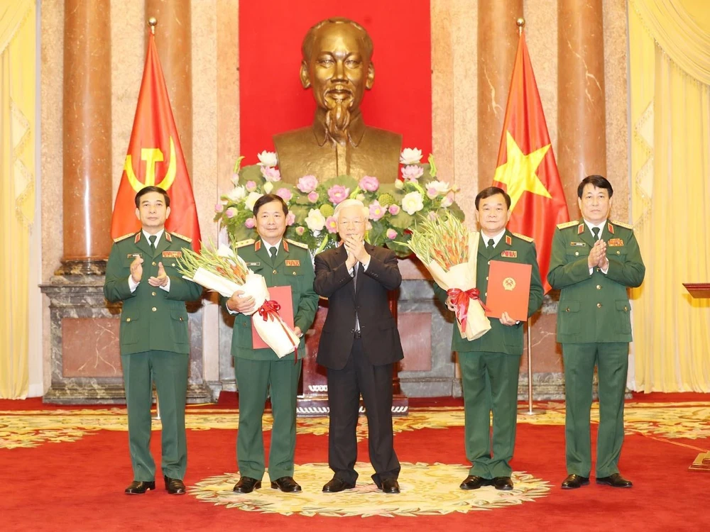 Tổng Bí thư, Chủ tịch nước Nguyễn Phú Trọng trao Quyết định thăng quân hàm Thượng tướng cho đồng chí Hoàng Xuân Chiến và đồng chí Lê Huy Vịnh. (Ảnh: Trí Dũng/TTXVN) 