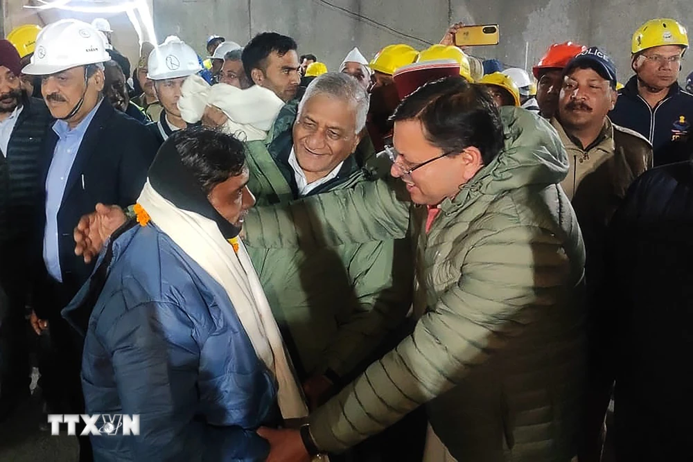 Thủ hiến bang Uttarakhand của Ấn Độ, ông Pushkar Singh Dhami (phải, phía trước) thăm hỏi sức khỏe một công nhân (trái, phía trước) vừa được giải cứu sau 17 ngày mắc kẹt trong đường hầm bị sập ở Uttarkashi, bang Uttarakhand, ngày 28/11/2023. (Ảnh: AFP/TTXVN)