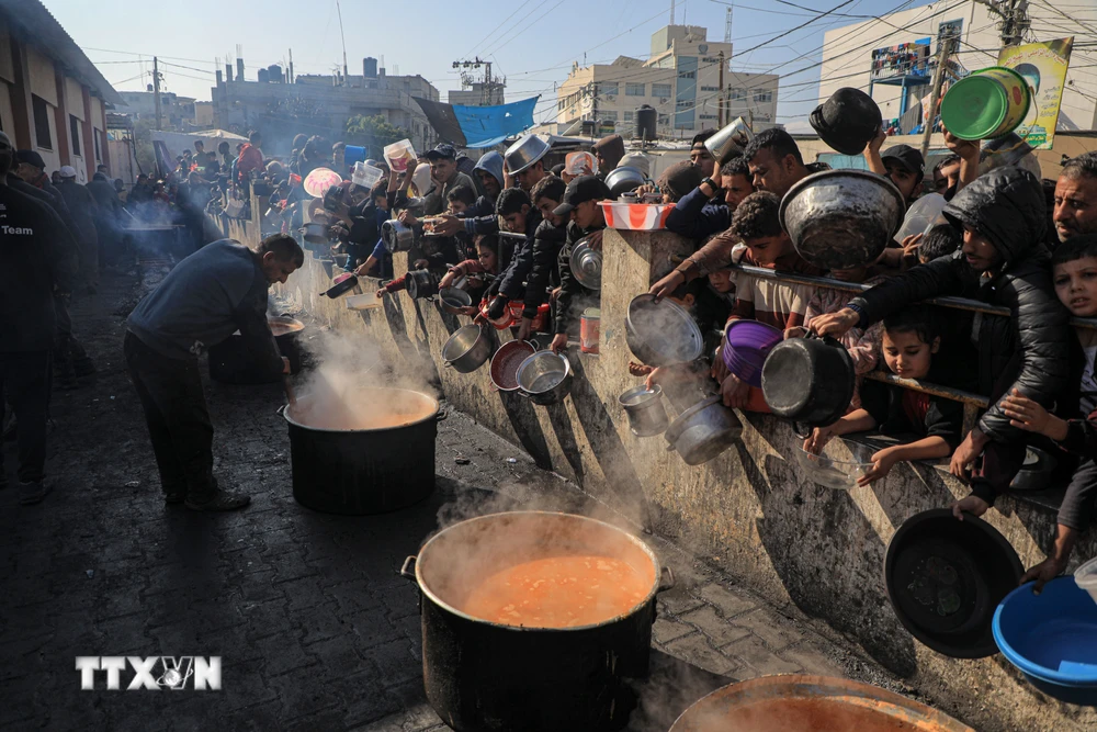 Người dân chờ nhận thực phẩm cứu trợ tại thành phố Rafah, phía Nam Dải Gaza ngày 31/12/2023. (Ảnh: THX/TTXVN)