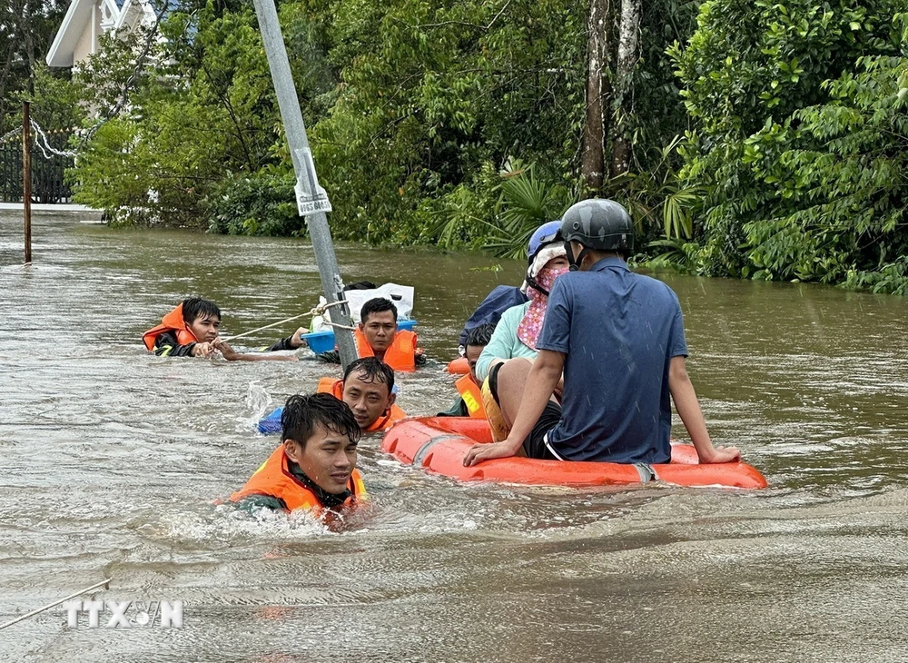 Cán bộ, chiến sỹ Ban Chỉ huy quân sự thành phố Phú Quốc cùng với lực lượng tại địa phương ứng cứu, sơ tán người dân đến nơi an toàn. (Ảnh: TTXVN phát)