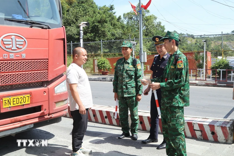 Lực lượng hải quan và biên phòng Cửa khẩu Quốc tế Hữu Nghị phối hợp kiểm soát phương tiện nhập khẩu hàng hóa vào Việt Nam. (Ảnh: Quang Duy/TTXVN)