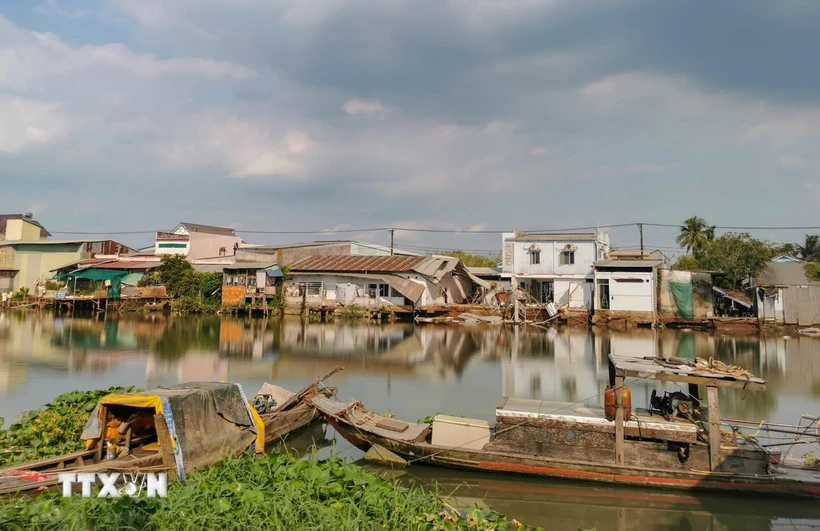 Những căn nhà bị sạt lở trên sông Trà Nóc ngày 3/4 nhìn từ phía phường Trà Nóc. (Ảnh: Thanh Liêm/TTXVN)