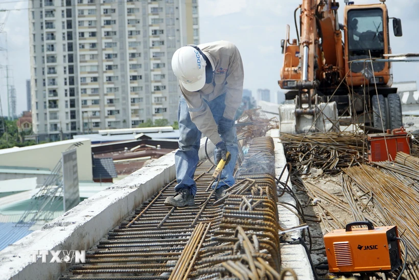 Công nhân thi công trên công trường dự án xây dựng cầu Nam Lý. (Ảnh: Tiến Lực/TTXVN)